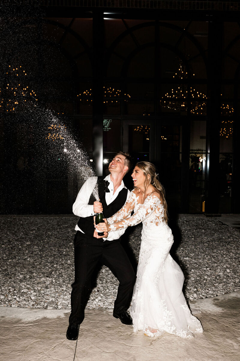 glass on enchanted acres wedding champagne pop with direct flash